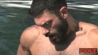 Bearded beauty Bob Hager jerks off in a pool on a sunny day